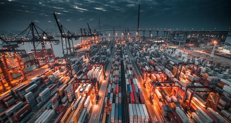 Container port with cranes at dusk